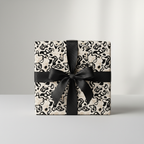 Abstract black and beige wrapping paper with a chic black ribbon and bow, perfect for modern luxury gifts.