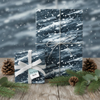 Abstract navy and white Christmas gift wrap with silver ribbon on wood table with pinecones.