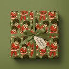 Black Santa wrapping paper with retro afro pattern and green ribbon by Wrapped Studios.
