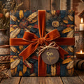 Rustic gift wrap on wooden planks, featuring orange velvet ribbon and stylized feather patterns.