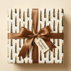 Bullet wrapping paper with a brown satin bow on a gift box by Wrapped Studios.