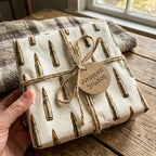 Rustic bullet wrapping paper by Wrapped Studios on a gift box tied with twine.