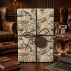 Vintage map wrapping paper on a luxury retirement gift with leather bow and tag by Wrapped Studios.