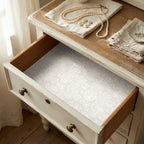 Vintage cream angel wrapping paper used as a drawer liner in a rustic dresser by Wrapped Studios.