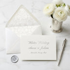 Elegant winter wedding invitation card with angel envelope liner and wax seal by Wrapped Studios.