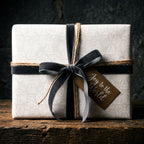 Elegant angel Christmas gift wrap with grey velvet ribbon and holiday tag, by Wrapped Studios.
