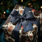 Luxury vintage Christmas wrapping paper with a winter forest pattern and navy bow, by Wrapped Studios.