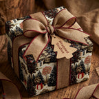 Rustic Christmas gift wrap by Wrapped Studios with a winter forest pattern and burlap ribbon.