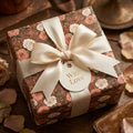 Vintage floral wrapping paper with cream satin ribbon and 'With Love' gift tag by Wrapped Studios.