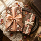 Vintage rose floral wrapping paper with luxury satin ribbon on gift boxes by Wrapped Studios.