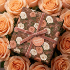 Luxury vintage floral wrapping paper with a pink velvet ribbon on a gift box by Wrapped Studios.