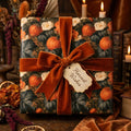 Luxury autumn pumpkin wrapping paper with a rust velvet bow and harvest tag by Wrapped Studios.