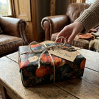 Rustic pumpkin and floral wrapping paper on an autumn gift box by Wrapped Studios.