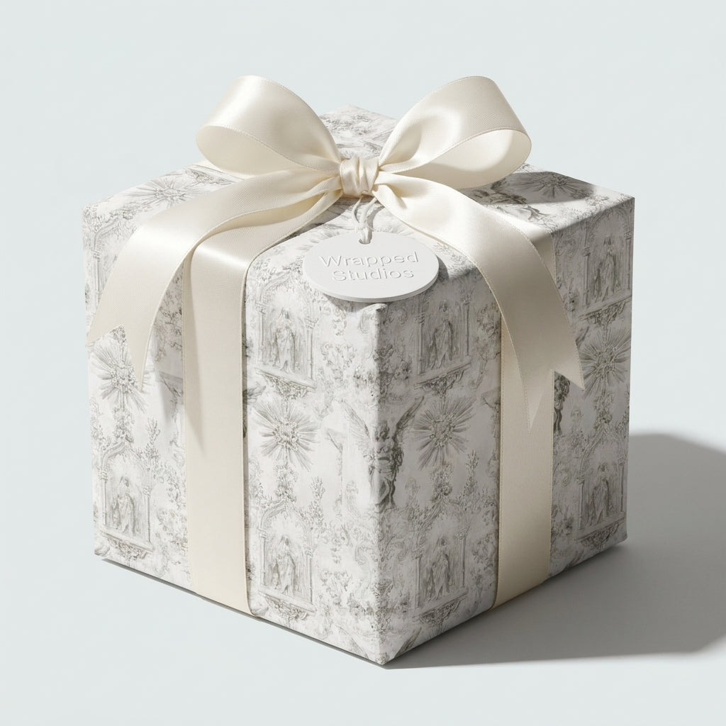 Luxury vintage toile wrapping paper with cream satin ribbon on a gift box by Wrapped Studios.