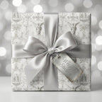 Vintage angel wrapping paper with a luxury silver satin bow and Wrapped Studios gift tag.
