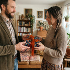 Giving a gift wrapped in floral paper with orange velvet ribbon from Wrapped Studios.
