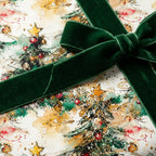 Christmas gift box wrapped in watercolor tree paper with dark green velvet ribbon.