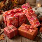 Cozy fall apple wrapping paper on gift boxes with ribbons in a rustic autumn setting by Wrapped Studios.