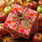 Autumn apple wrapping paper with a twine bow and thank you tag by Wrapped Studios.