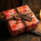Rustic autumn apple wrapping paper with a twine bow and leather tag, by Wrapped Studios.
