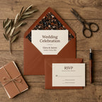 Boho terracotta wedding invitation with dark floral envelope liner by Wrapped Studios.