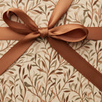 Elegant gift box with floral wrapping paper and copper ribbon bow.