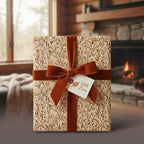 Rustic floral wrapping paper with a brown velvet bow and "With Love" tag, perfect for a cozy gift.