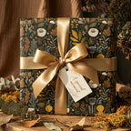 Elegant floral wrapping paper with a gold satin ribbon and "A special moment" tag.