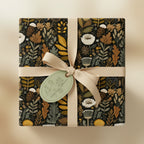 Square gift wrapped in elegant floral wrapping paper with tan ribbon.