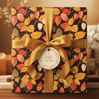 Elegant gift wrapped in brown floral wrapping paper with autumn leaves, tied with a gold satin ribbon.