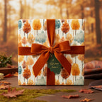 Autumn-themed gift box wrapped in watercolor tree print paper with rust-colored velvet ribbon.
