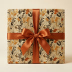 Square gift wrapped in autumn floral wrapping paper and copper satin ribbon bow from Wrapped Studios.