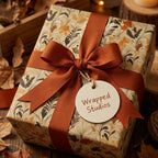 Autumn floral gift wrap by Wrapped Studios with a burnt orange ribbon and tag.