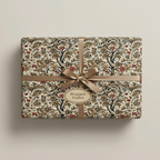 Elegant floral wrapping paper on a rectangular gift box with a gold ribbon and bow.