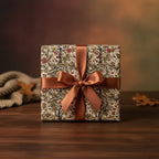 Elegant gift wrapped in vintage-style floral wrapping paper with a brown satin ribbon, perfect for a birthday or special occasion.