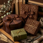 Elegant floral wrapping paper in brown, green, and gold, tied with ribbon. Perfect luxury gift wrap by Wrapped Studios.