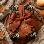 Autumn gift wrap with pumpkin floral print, rust ribbon, and Happy Fall tag by Wrapped Studios.