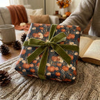 Cozy fall pumpkin wrapping paper with a luxury green velvet bow by Wrapped Studios.
