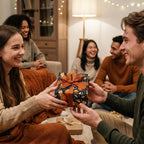 Group exchanging gifts wrapped in navy floral wrapping paper with a copper-colored ribbon in a cozy home.