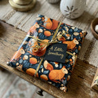 Gift wrapped in autumn-themed paper with gold ribbon and tag on a wooden surface. Autumn squirrel gift wrap on present.