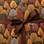 Stylish gift wrap with a dark brown ribbon on an autumnal tree pattern, perfect for fall birthdays.