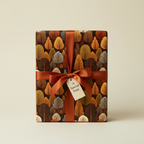 Autumn trees pattern gift wrapped with burnt orange ribbon and "A Special Treat" tag.