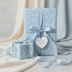 Baby blue gift wrap with white raindrop pattern and "Always Together" tag, tied with a satin bow.