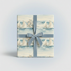 Elegant sailboat wrapping paper featuring a blue velvet ribbon tied around a rectangular gift box.