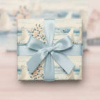 Elegant gift wrapped in floral sailboat wrapping paper with a light blue satin ribbon.