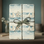 Elegant gift wrapped in sailboat wrapping paper with floral accents and a sage green ribbon.