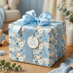 Light blue baby shower gift wrap with a teddy bear and floral pattern and matching ribbon. Tag reads "For Baby".