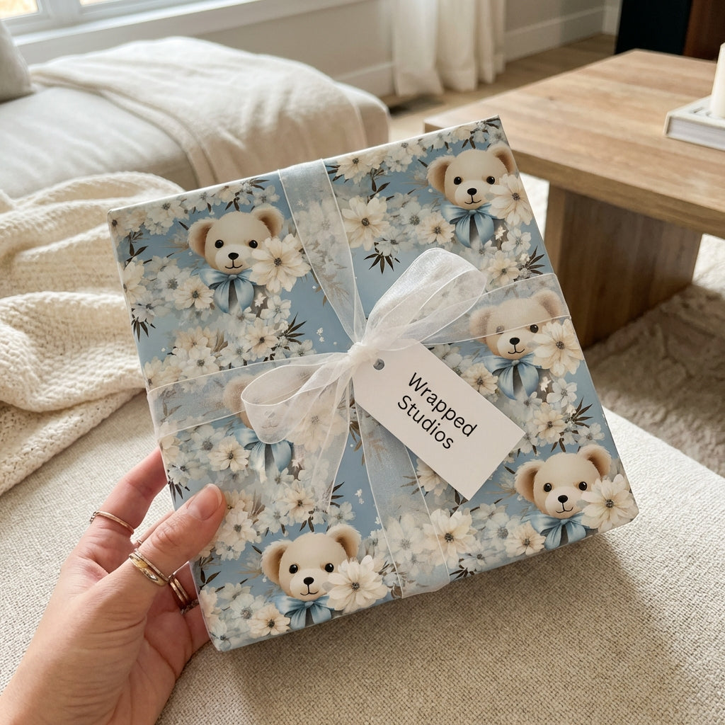 Wrapped Studios baby shower gift wrap. Light blue wrapping paper with teddy bears and white floral pattern.