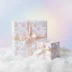 Princess castle fairy tale wrapping paper with peach ribbon, perfect for a baby shower or girl's birthday gift.