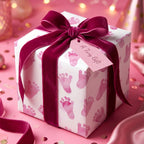 Baby shower gift: pink baby footprint wrapping paper with a velvet ribbon and "A Tiny Gift" tag.